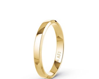 May include: A polished yellow gold band ring with a smooth, reflective surface. The interior of the ring is clearly engraved with the text 585 and AFJ, indicating the gold purity and maker's mark on this simple, circular jewelry piece.