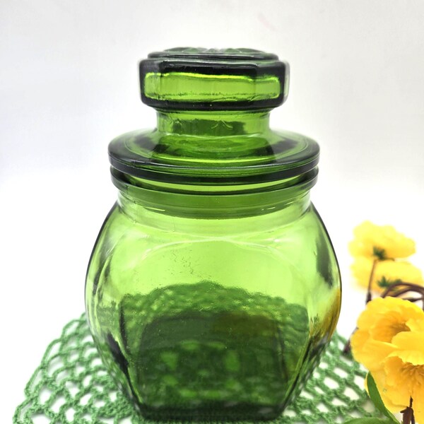 Frasco pequeño de vidrio verde esmeralda con tapa de burbujas en forma de margarita