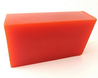 May include: A solid, rectangular block of vibrant red material. The block has a smooth surface and a slightly angled edge on one side. The object is set against a plain white background, highlighting its shape and color.
