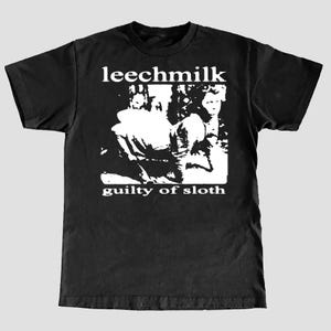 May include: Black t-shirt with white print that says "Leechmilk" and "Guilty of Sloth". The print features a black and white image of a person.