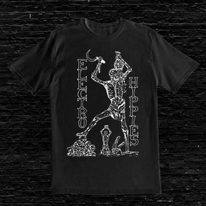 May include: Black t-shirt featuring a white graphic of a skeleton holding a sickle and a bag. The text "ELECTRO" and "HIPPIES" is printed vertically on either side of the skeleton.