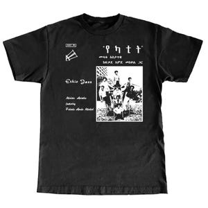 May include: Black t-shirt with a white graphic featuring a group of people and text in a foreign language. The shirt also has the words "Ethio Jazz" and the names "Mulatu Astatke" and "Fekade Ande Maskal".
