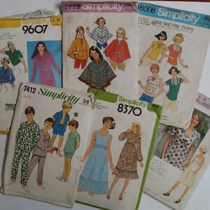 May include: A collection of vintage Simplicity sewing patterns featuring various designs for clothing. The patterns include a poncho, tops, dresses, and pyjamas. The patterns are in various colours, including blue, green, red, and yellow.