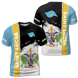 May include: A black and white t-shirt with a distressed design featuring the flag and coat of arms of Saint Lucia. The text "SAINT LUCIA" is printed vertically on the side of the shirt.