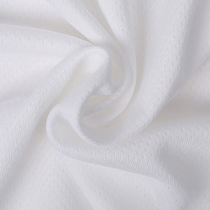 May include: White fabric with a smooth, textured surface. The fabric is folded and draped, showing its soft and flowing texture.