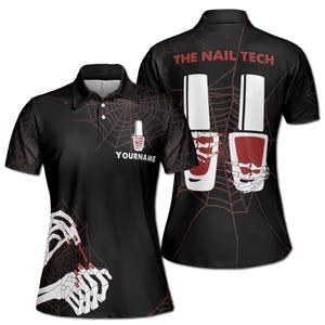 May include: Black and red women's golf shirt with a spiderweb pattern and nail polish bottles. The back of the shirt says "The Nail Tech".