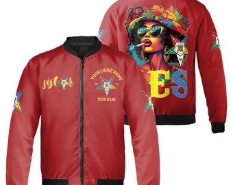 May include: Red satin bomber jacket with black zipper and black ribbed collar and cuffs. The jacket has a yellow star with a five-pointed star inside and the text "YOUR LODGE NAME" and "YOUR NAME" on the front. The back of the jacket has a colorful illustration of a woman wearing a hat and sunglasses with the text "ES" on the back.