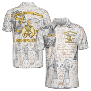 May include: A white polo shirt featuring an all-over print of Egyptian-themed illustrations, including pharaohs, deities, and hieroglyphics. The design includes a central emblem with a crescent moon, star, and sword, plus text placeholders.