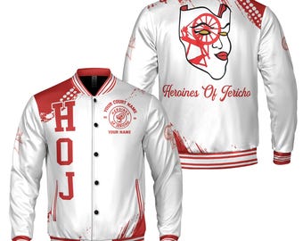 May include: White satin bomber jacket with red accents. The front features the letters "HOJ" in red, and a circular emblem with text. The back displays a graphic of a face and the words "Heroines Of Jericho".
