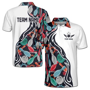 May include: White polo shirt with a bowling-themed design. The shirt features a black and colorful pattern of bowling pins and balls on the sides and back. The front has a bowling ball and pins logo with the text "YOUR NAME". The back has the text "TEAM NAME".