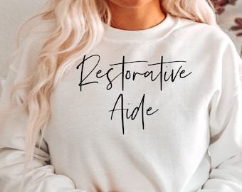 Restorative aide shirt, sweatshirt, hoodie, tank top, gift, restorative nurse, CNA, rehabilitation, rna