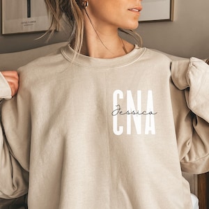 Personalized CNA shirt, sweatshirt, hoodie, long sleeve, gift, custom name pocket certified nursing assistant