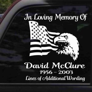 May include: In Loving Memory Of David McClure 1956 - 2003 Lines of Additional Wording. A black and white decal with an American flag and an eagle.