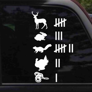 May include: A white vinyl sticker with a deer, rabbit, squirrel, turkey, and snake, with tally marks next to each animal. The tally marks indicate the number of each animal that has been seen.