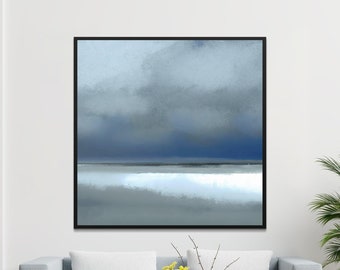 Puede incluir: Pintura abstracta de un paisaje marítimo con un cielo azul y nubes blancas. La pintura está enmarcada en negro y cuelga de una pared blanca sobre un sofá gris.