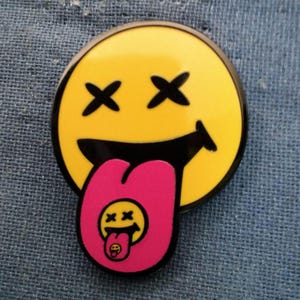 Smiley Face Spun Roller hard enamel pin 1 inch by 1.12 inch