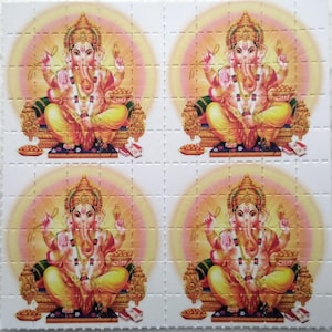 May include: A sheet of perforated squares, each featuring a vibrant illustration of the Hindu deity Ganesha. The artwork depicts Ganesha seated, adorned in gold and yellow hues, against a soft, radiating background. The overall theme is religious and spiritual.