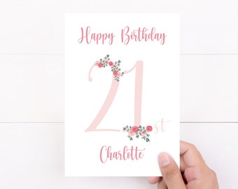 May include: A white card with pink floral accents and the text "Happy Birthday 21st Charlotte".