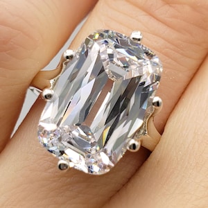 May include: A set of three ceramic mugs with a speckled, matte finish. The mugs are in shades of cream, light gray, and dark gray. Each mug has a simple, minimalist design, perfect for coffee or tea.