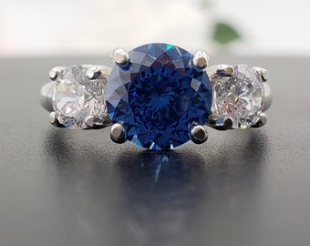 Emerald Cut & Pear Shaped Sapphire & Diamond Three-Stone Ring in Sterling Silver Emerald Cut & Pear Shaped Sapphire & Diamond Three-Stone Ring in Sterling Silver