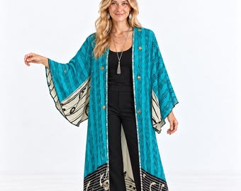 May include: A long, open-front kimono featuring a vibrant teal upper section with a wavy pattern and a contrasting black lower panel decorated with musical notes and staff lines. The garment has wide, flowing sleeves and a straight, floor-length cut.