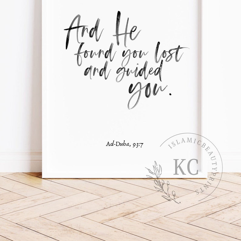 May include: Black and white calligraphy print with the text "And He found you lost and guided you."  The text is in a cursive font and is centered on a white background. The text "Ad-Duha, 93:7" is printed below the calligraphy in a smaller font.
