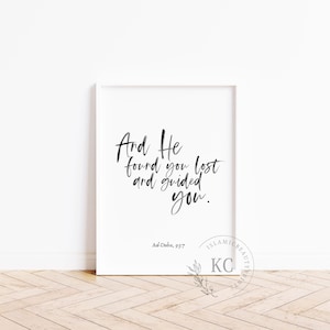 May include: Black and white calligraphy print with the text "And He found you lost and guided you."  The text is in a modern calligraphy style. The print also includes the text "Ad-Duba, 93:7".