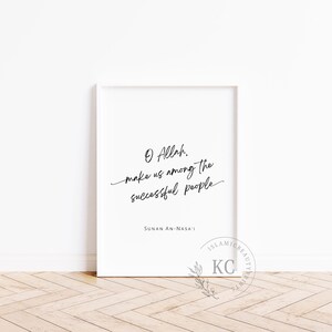 May include: A white framed print with a black calligraphy quote that reads "O Allah, make us among the successful people." The quote is attributed to Sunan An-Nasa'i.