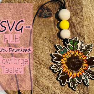 May include: A digital download SVG file of a sunflower with green leaves, perfect for crafting projects. The file is Glowforge tested. The image also shows a wooden bead necklace with white and yellow beads.