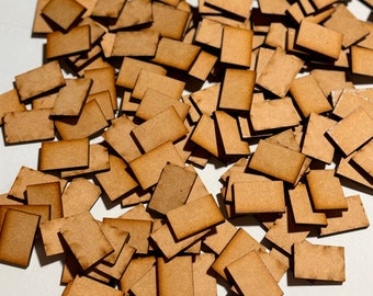 May include: A large pile of small, rectangular wooden pieces. The pieces are a light brown color and have a rough, unfinished texture.