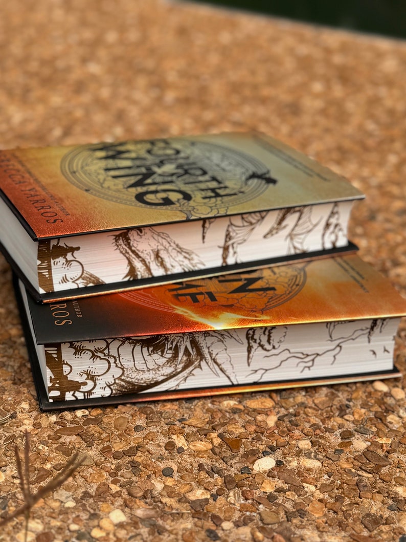 May include: Two fantasy novels stacked on top of each other. The top book is titled "Fourth Wing" and the bottom book is titled "Fire in the  Deep". Both books have black covers with gold and white illustrations.