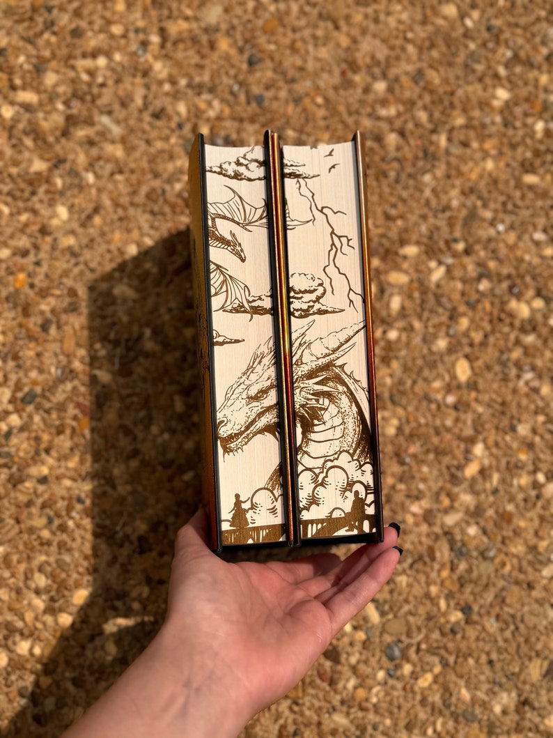 May include: Two hardback books with brown and white illustrated covers featuring a dragon and clouds. The books are bound in black with gold accents.