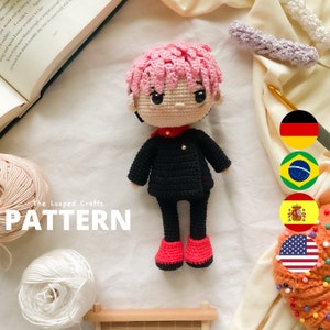May include: Crochet amigurumi pattern for a doll with pink hair, black clothing, and red shoes. The pattern is available in multiple languages, including German, Brazilian Portuguese, Spanish, and American English. The image also includes the text "The Looped Crafts PATTERN".