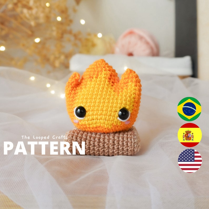 May include: Crochet pattern for a cute campfire amigurumi toy. The pattern includes instructions for making a fire with a log base and a yellow and orange flame with a smiling face.