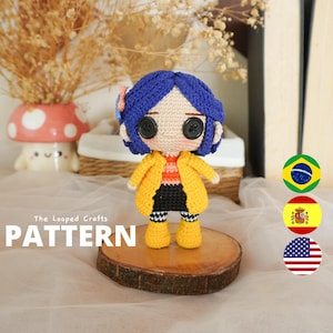 May include: A handmade crochet doll with blue hair, black button eyes, and a yellow coat. The doll is wearing a black skirt and yellow boots. The text "PATTERN" is displayed below the doll. The doll is displayed on a wooden slice.