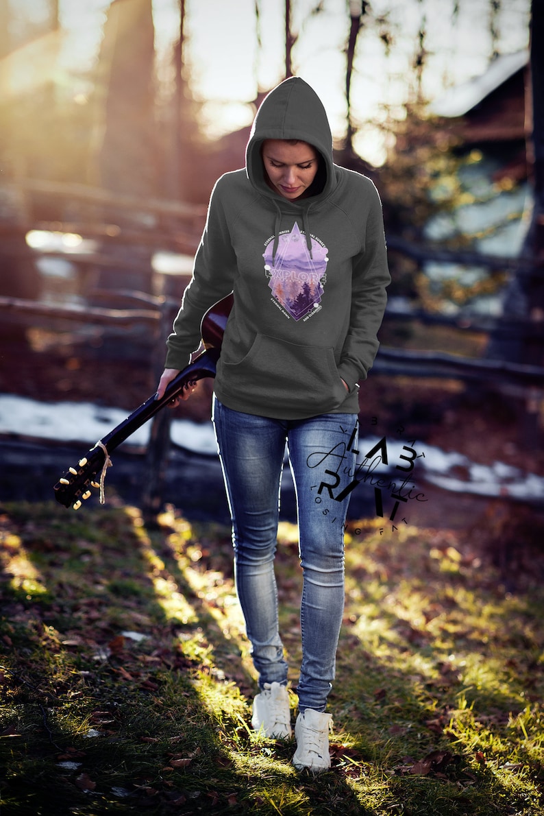 May include: A gray hooded sweatshirt with a geometric design featuring a purple mountain landscape and the word "Explore".