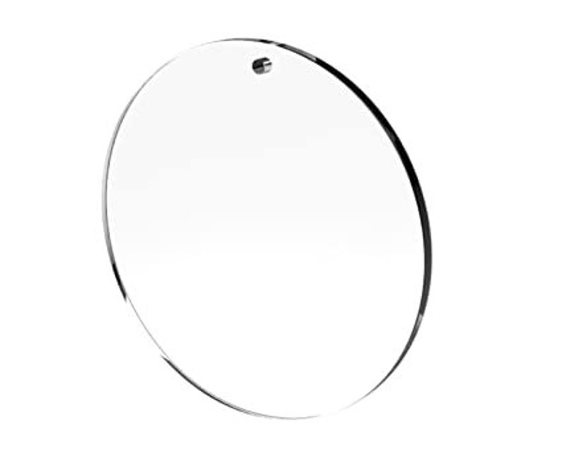 May include: A clear round acrylic blank ornament with a hole at the top for hanging.