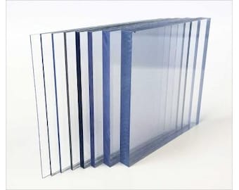 May include: A stack of clear and translucent blue acrylic sheets of varying thicknesses. The sheets are stacked in a staggered pattern, with the largest sheet on the bottom and the smallest sheet on top.