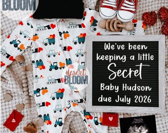 May include: An announcement of a baby's arrival, featuring a white onesie with truck and heart patterns, red baby shoes, a black beanie, and a letter board that reads "We've been keeping a little Secret Baby Hudson due July 2026."