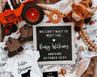 May include: A black letter board with the text "We can't wait to meet you Baby Williams Arriving October 2024". The letter board is surrounded by a variety of baby-themed items, including a toy tractor, a pair of brown cowboy boots, a stuffed brown cow, a white onesie with the text "Future Showman" and a black silhouette of a cow, a wooden bead garland, a gray and white blanket, and a black and white ultrasound image.