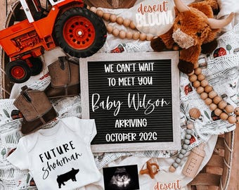 May include: A baby announcement with a rustic theme. The image includes a letter board with the text "WE CAN'T WAIT TO MEET YOU Baby Wilson ARRIVING OCTOBER 2026". Other items include a toy tractor, baby boots, and a onesie that says "FUTURE Showman".
