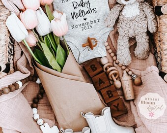 May include: A gray onesie with the text "For this child we have prayed Baby Williams November 2025".  The onesie is surrounded by a bouquet of pink tulips, a stuffed animal, wooden blocks spelling "BABY", a wooden rattle, a baby bottle, and a white cross.