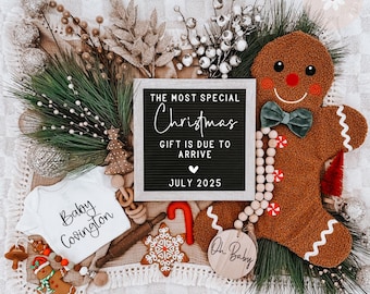 May include: A Christmas-themed baby announcement with a black letter board that reads "The most special Christmas gift is due to arrive July 2025". The letter board is surrounded by a gingerbread man, a baby onesie, and other Christmas decorations.