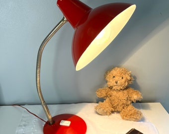 Bedside or desk lamp with flexible gold base and shiny red sheet metal vintage 60s