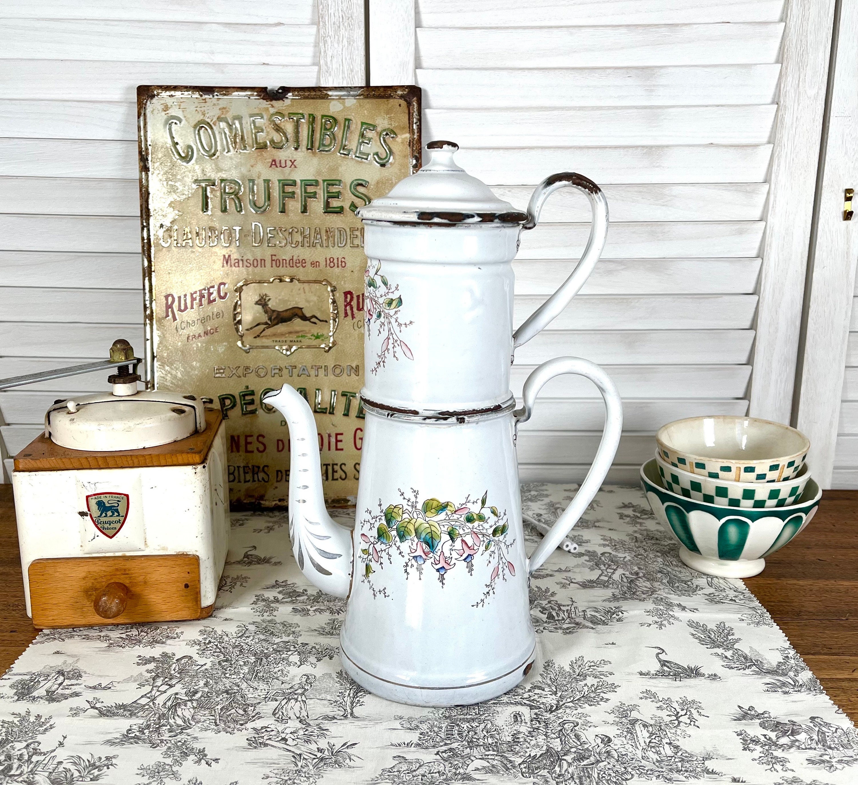Old enameled coffee pot decorated with flowers, high shape
