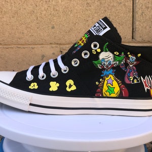 May include: Black high-top Converse sneakers with a custom design featuring clowns, popcorn, and the text "Killjoy From Outer Space".