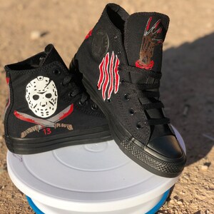 May include: Black high-top trainers with hand-painted designs inspired by the horror films Friday the 13th and A Nightmare on Elm Street. One trainer features Jason Voorhees' hockey mask and a machete, while the other trainer features Freddy Krueger's clawed glove.