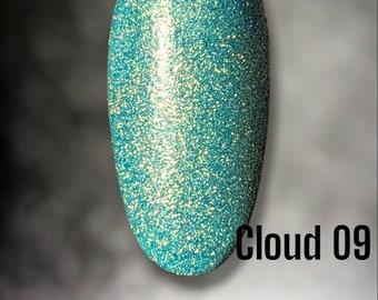 May include: A teal blue nail polish with a shimmery finish. The polish is called "Bloom Dip" and the colour is "Cloud 09".