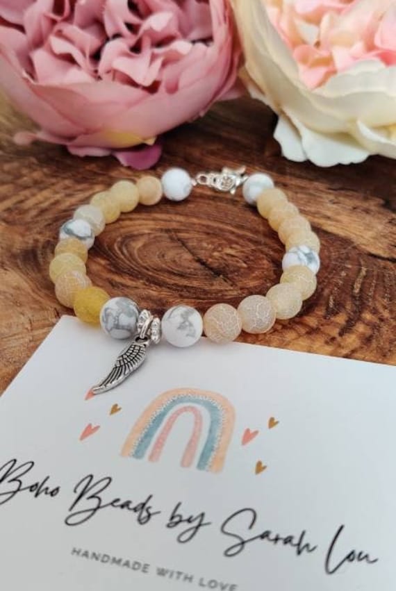 Yellow agate and Howlite beaded bracelet with silver plated angel wing charm