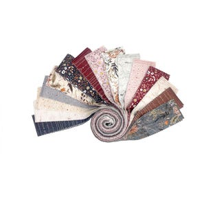 May include: A roll of fabric strips with various floral patterns in shades of pink, brown, gray, and white. The fabric is arranged in a fan shape, with the ends of the strips rolled up.